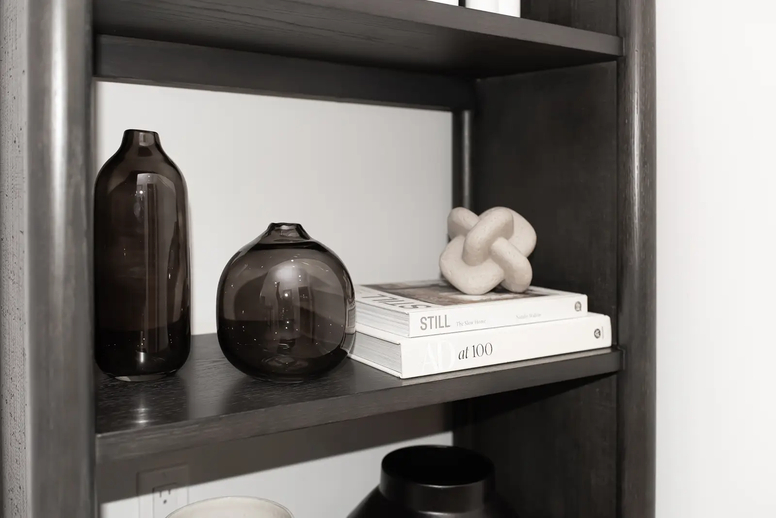 Interior of a Thornhill detached house renovation, with pale wood floors, black furnishings, and a walnut vanity in the primary bathroom.