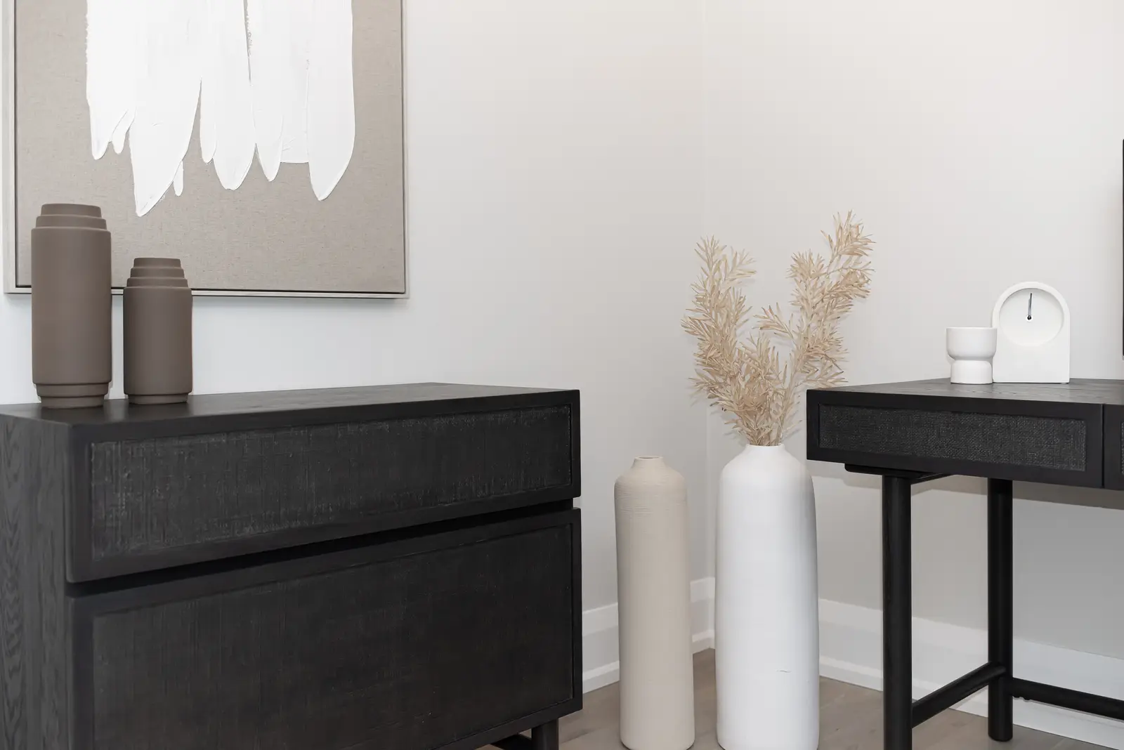 Interior of a Thornhill detached house renovation, with pale wood floors, black furnishings, and a walnut vanity in the primary bathroom.