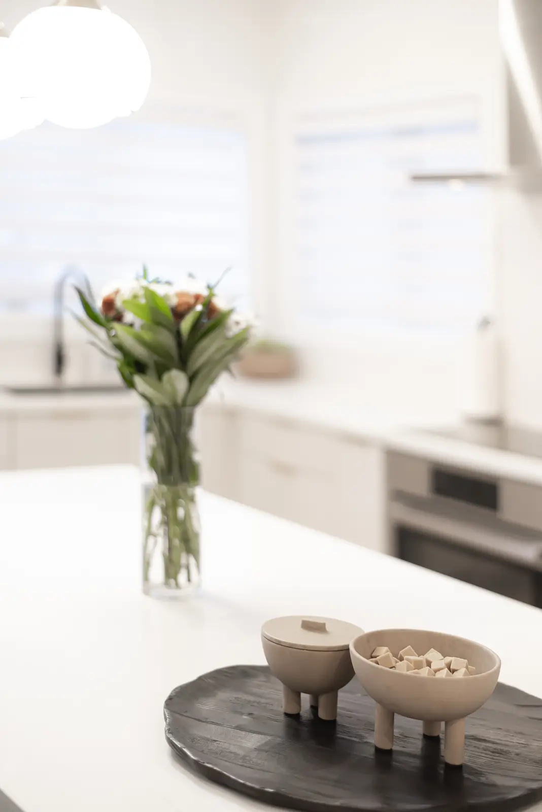 Interior of a Thornhill detached house renovation, with pale wood floors, black furnishings, and a walnut vanity in the primary bathroom.