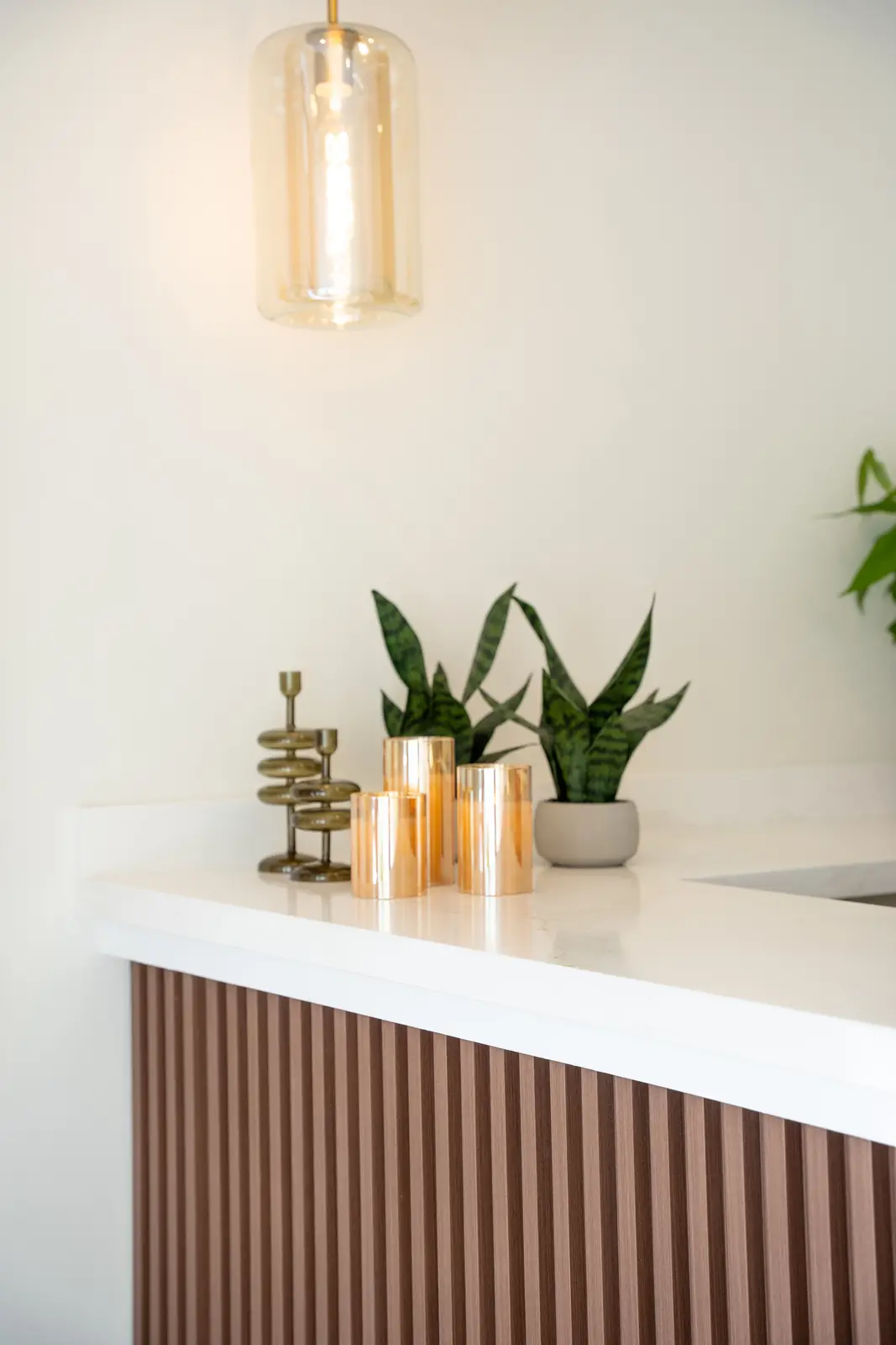 Reception of a Thornhill salon, with a fluted wood desk, a white counter, and a gold Beautique logo.