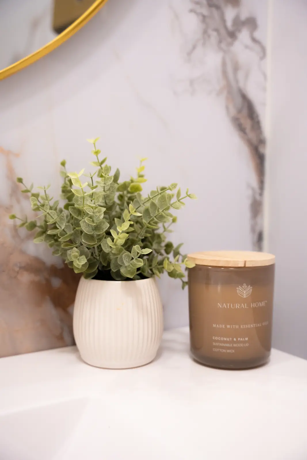 Reception of a Thornhill salon, with a fluted wood desk, a white counter, and a gold Beautique logo.