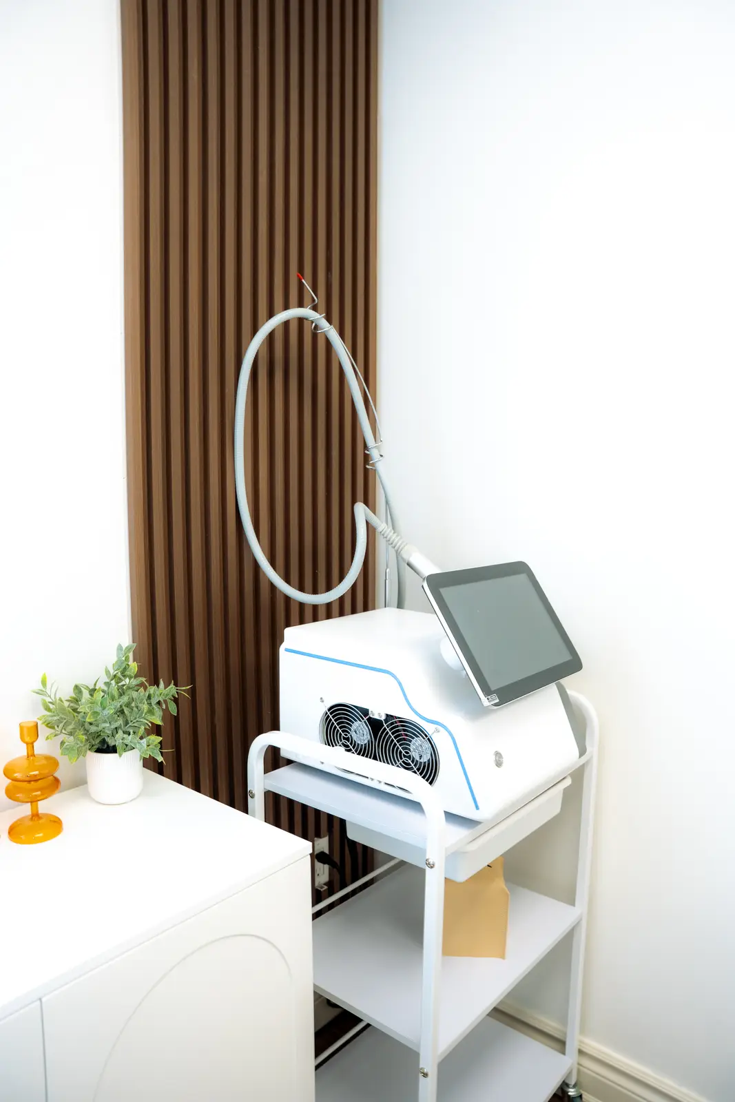 Reception of a Thornhill salon, with a fluted wood desk, a white counter, and a gold Beautique logo.
