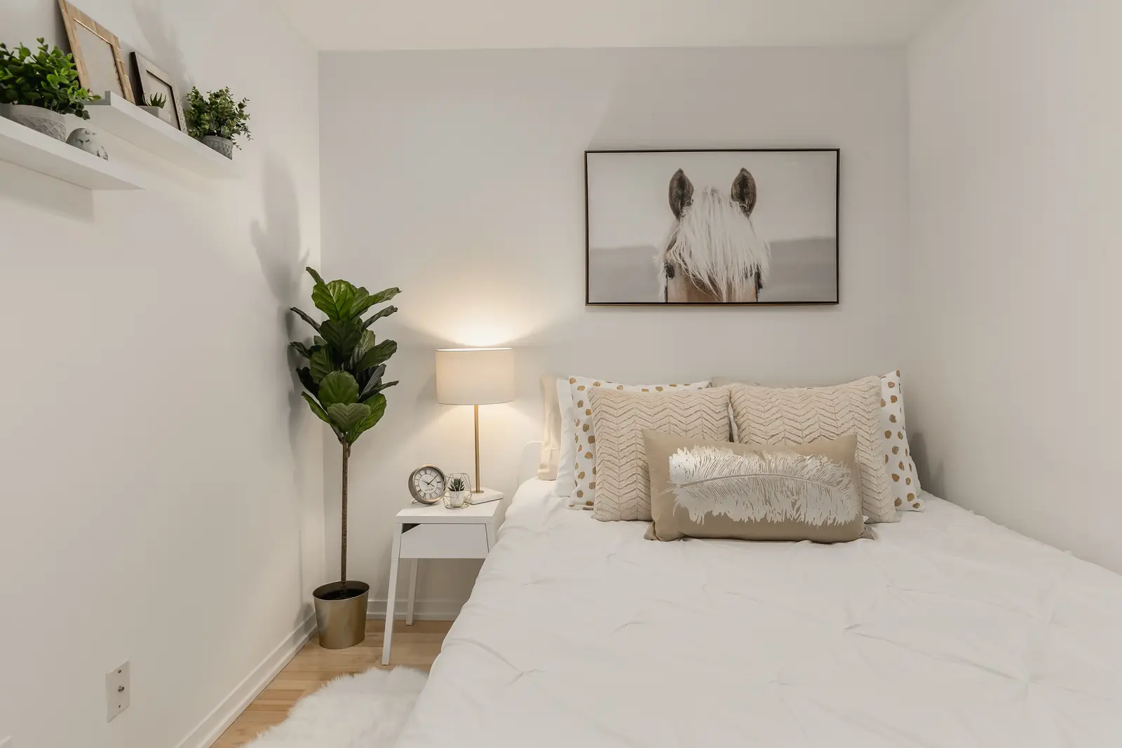 Interior of a downtown Toronto condo, with a wood kitchen, a grey sofa, and a balcony.