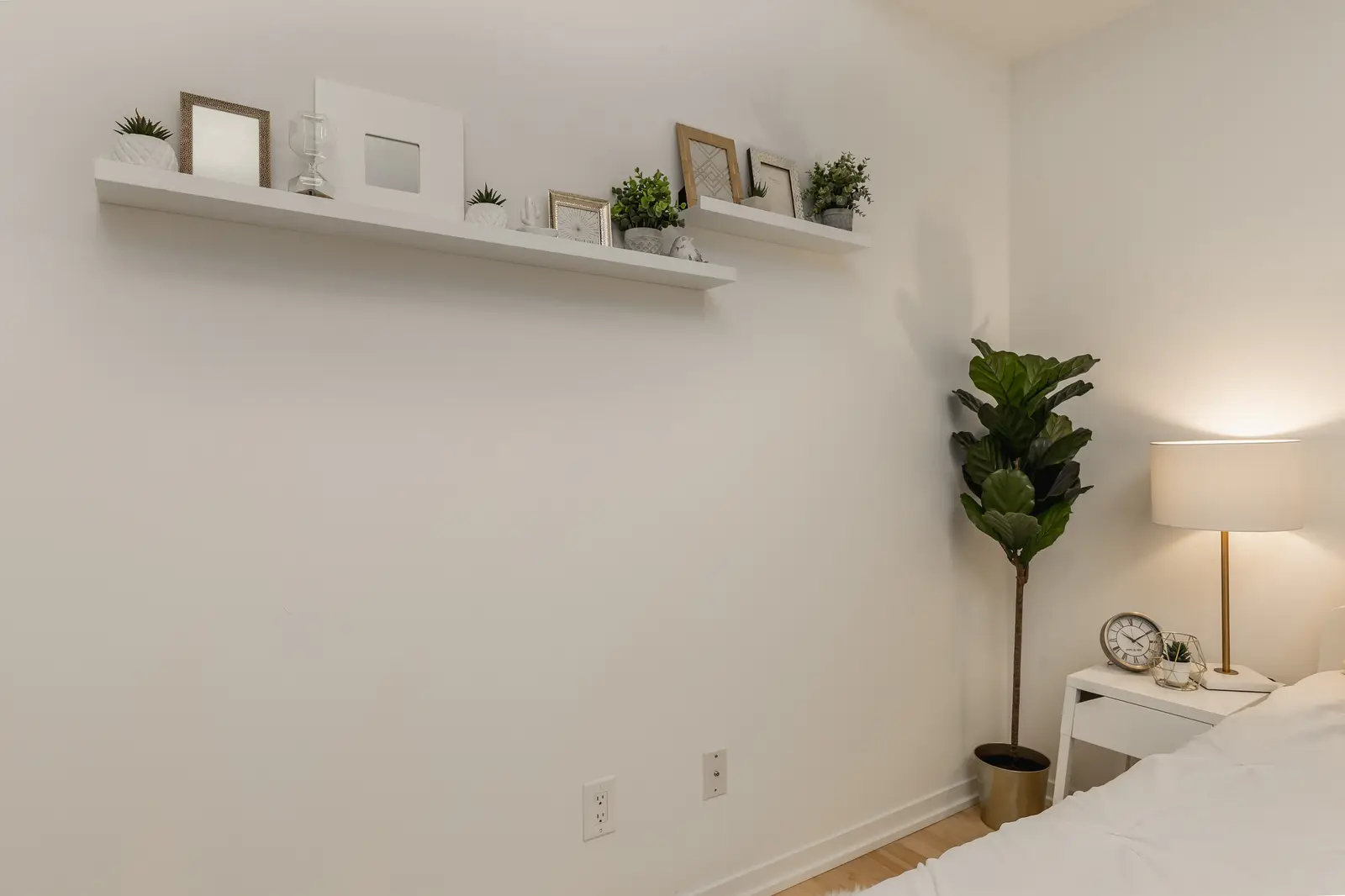 Interior of a downtown Toronto condo, with a wood kitchen, a grey sofa, and a balcony.