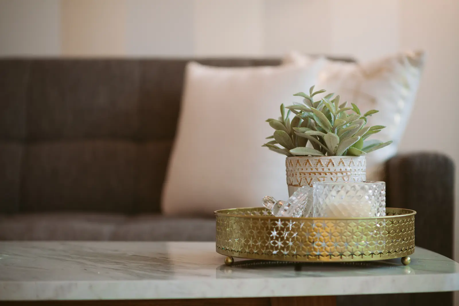 Interior of a downtown Toronto condo, with a wood kitchen, a grey sofa, and a balcony.