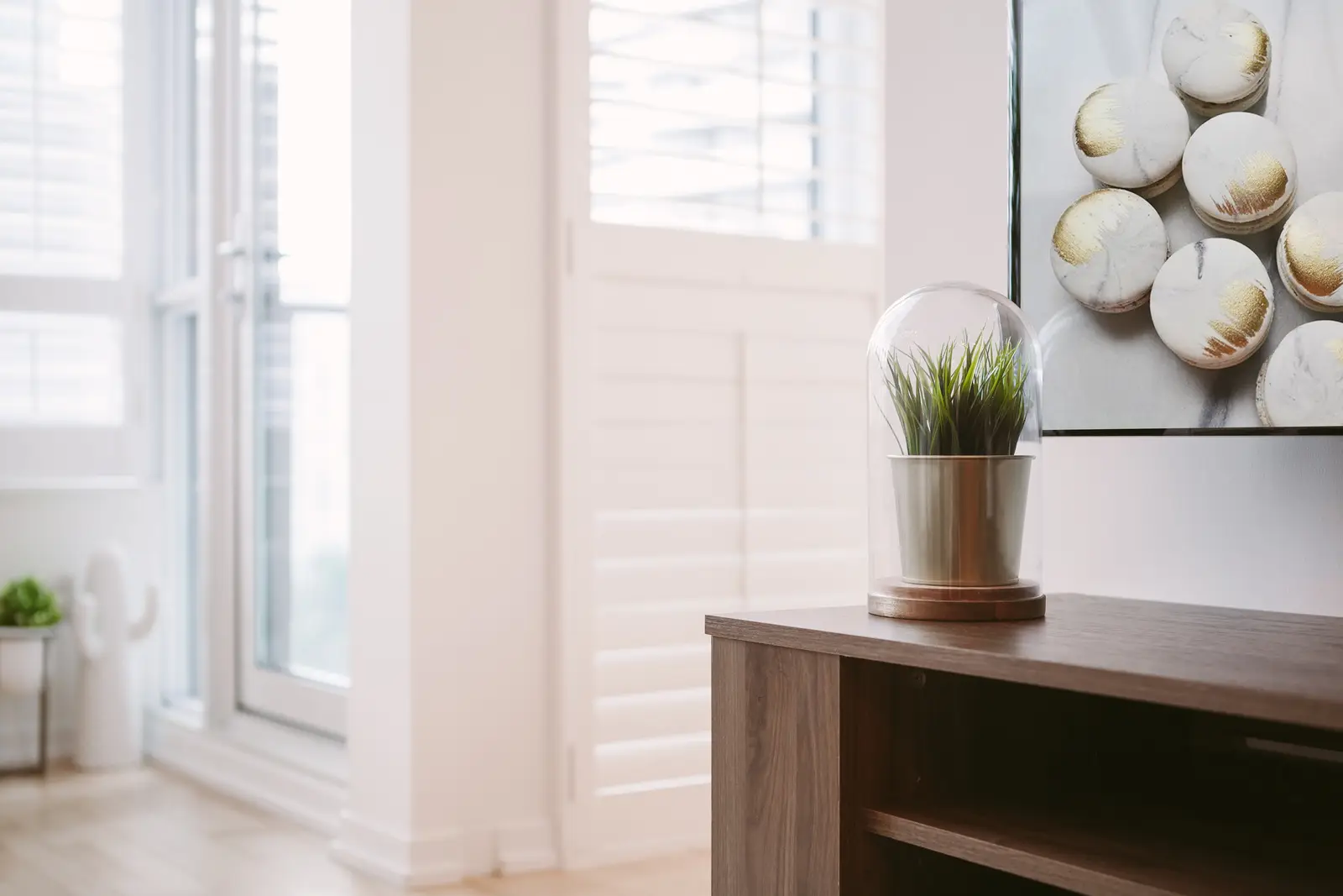 Interior of a downtown Toronto condo, with a wood kitchen, a grey sofa, and a balcony.