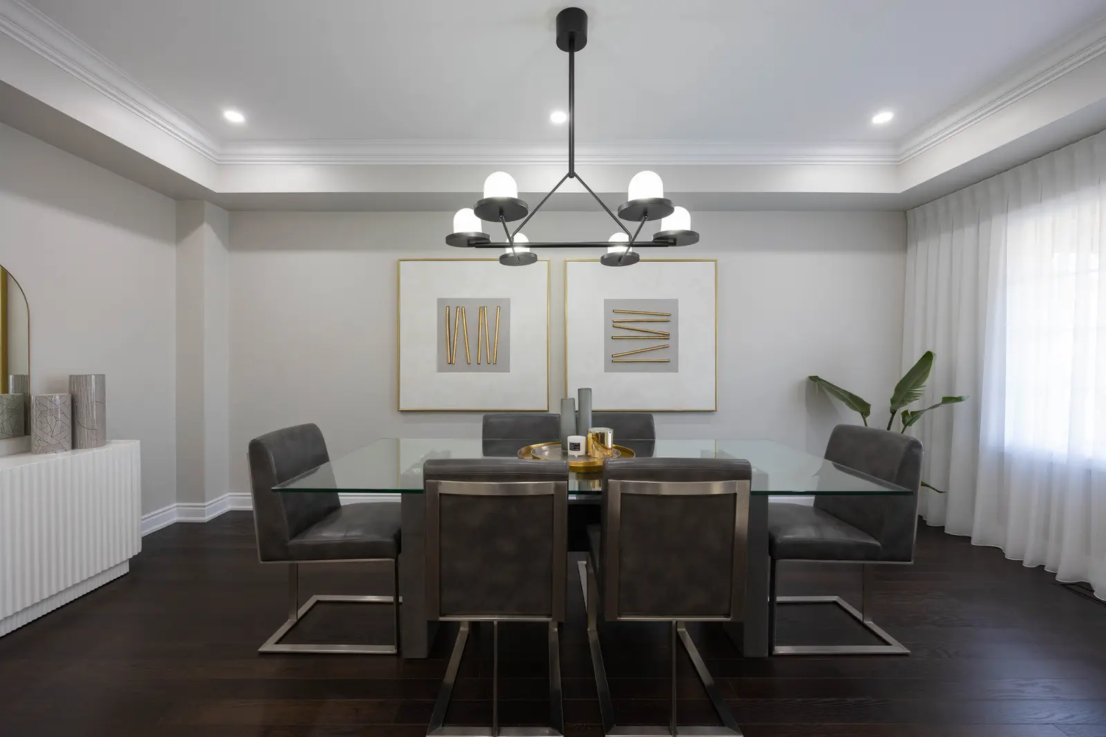Interior of a Vaughan house, with white cabinetry, dark wood floors, and marble.