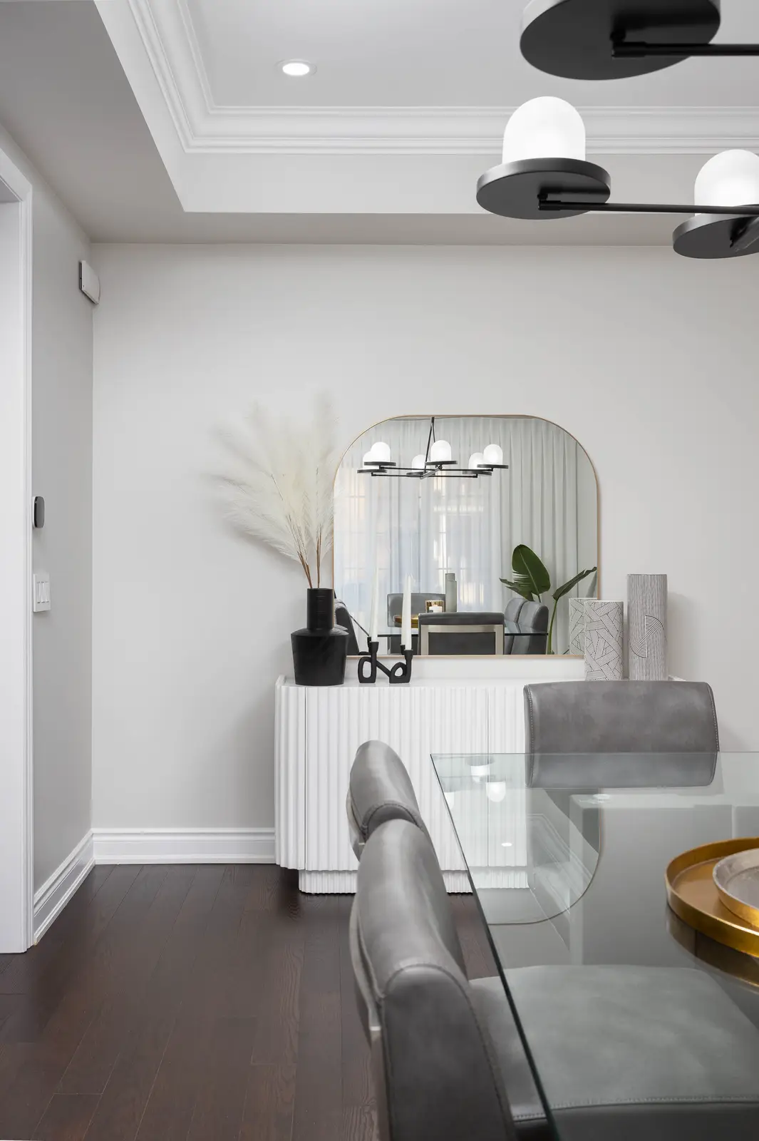 Interior of a Vaughan house, with white cabinetry, dark wood floors, and marble.