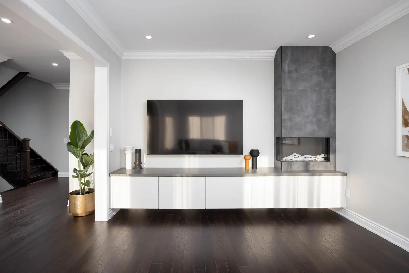 Interior of a Vaughan house, with white cabinetry, dark wood floors, and marble.
