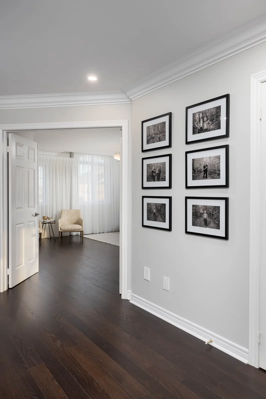 Interior of a Vaughan house, with white cabinetry, dark wood floors, and marble.