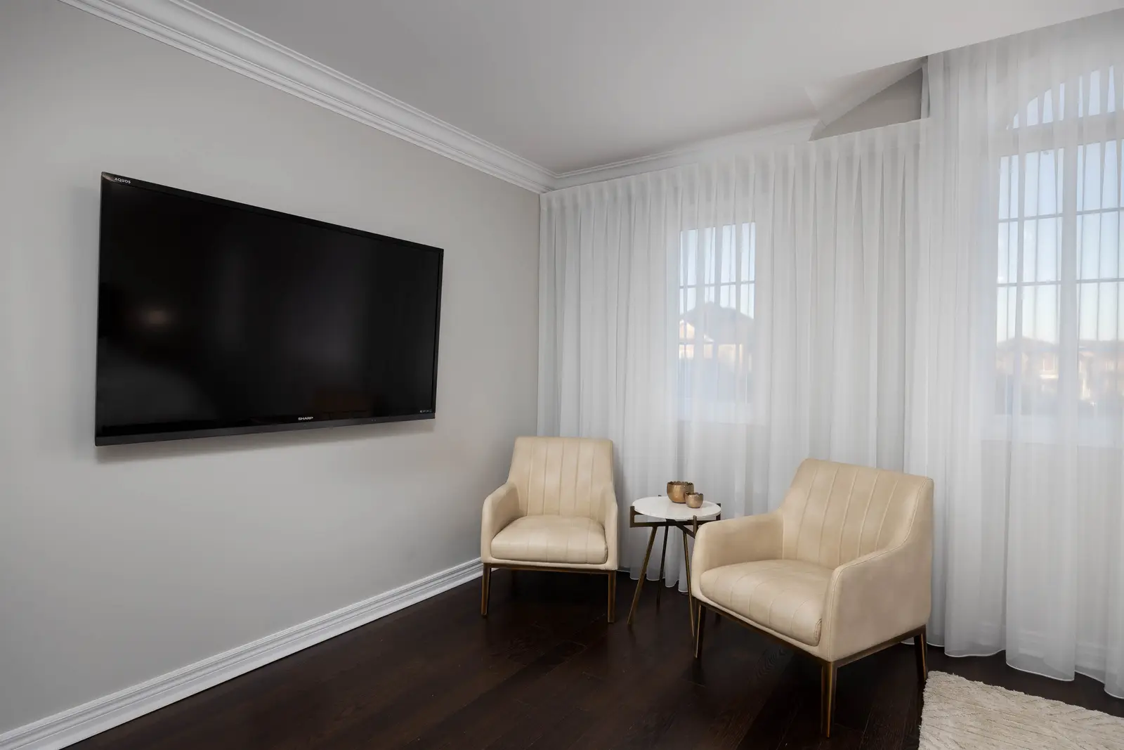 Interior of a Vaughan house, with white cabinetry, dark wood floors, and marble.