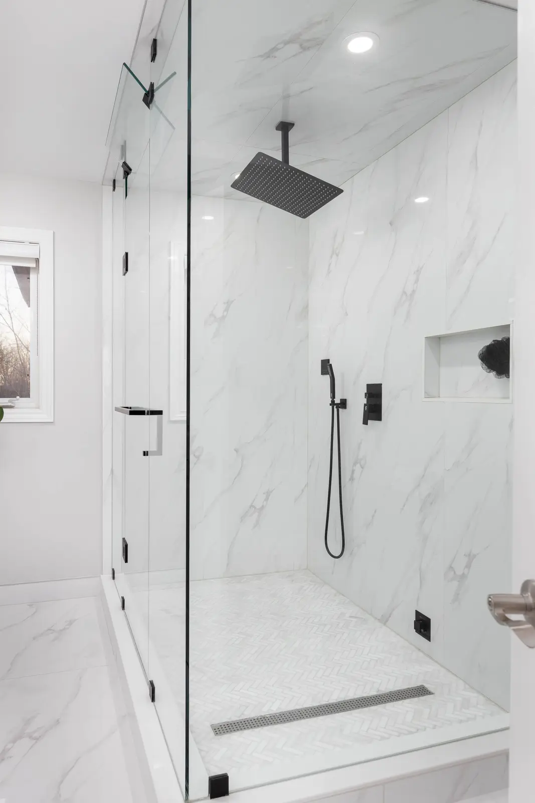 Interior of a Vaughan house, with white cabinetry, dark wood floors, and marble.