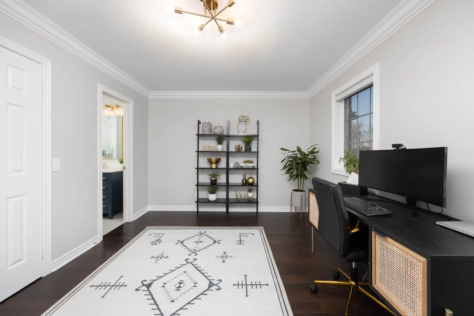 Interior of a Vaughan house, with white cabinetry, dark wood floors, and marble.