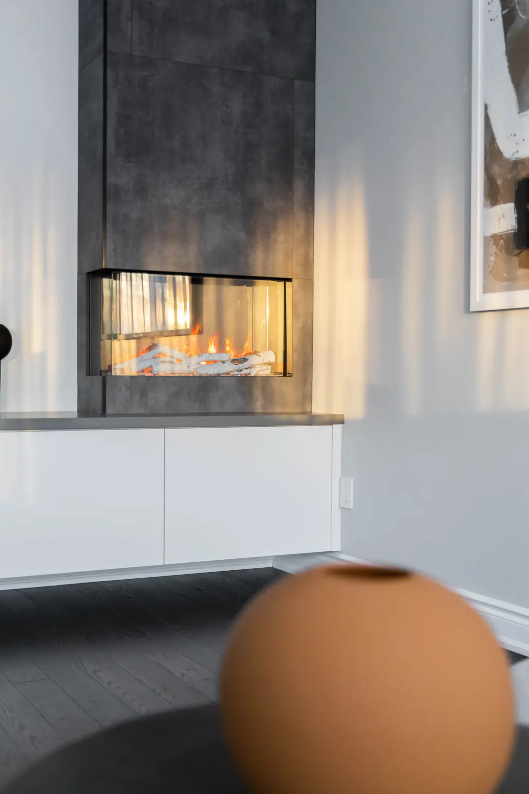 Interior of a Vaughan house, with white cabinetry, dark wood floors, and marble.