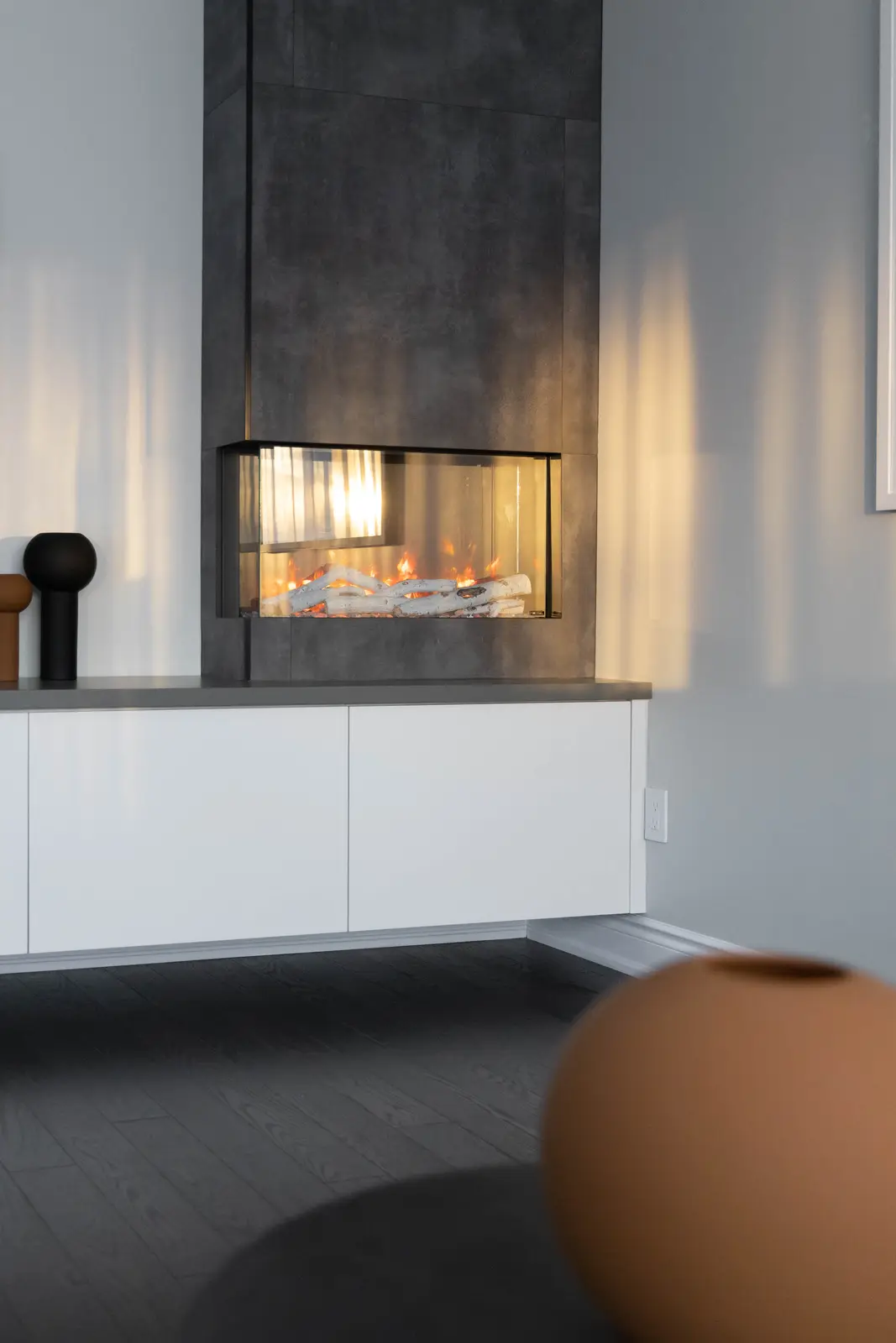 Interior of a Vaughan house, with white cabinetry, dark wood floors, and marble.