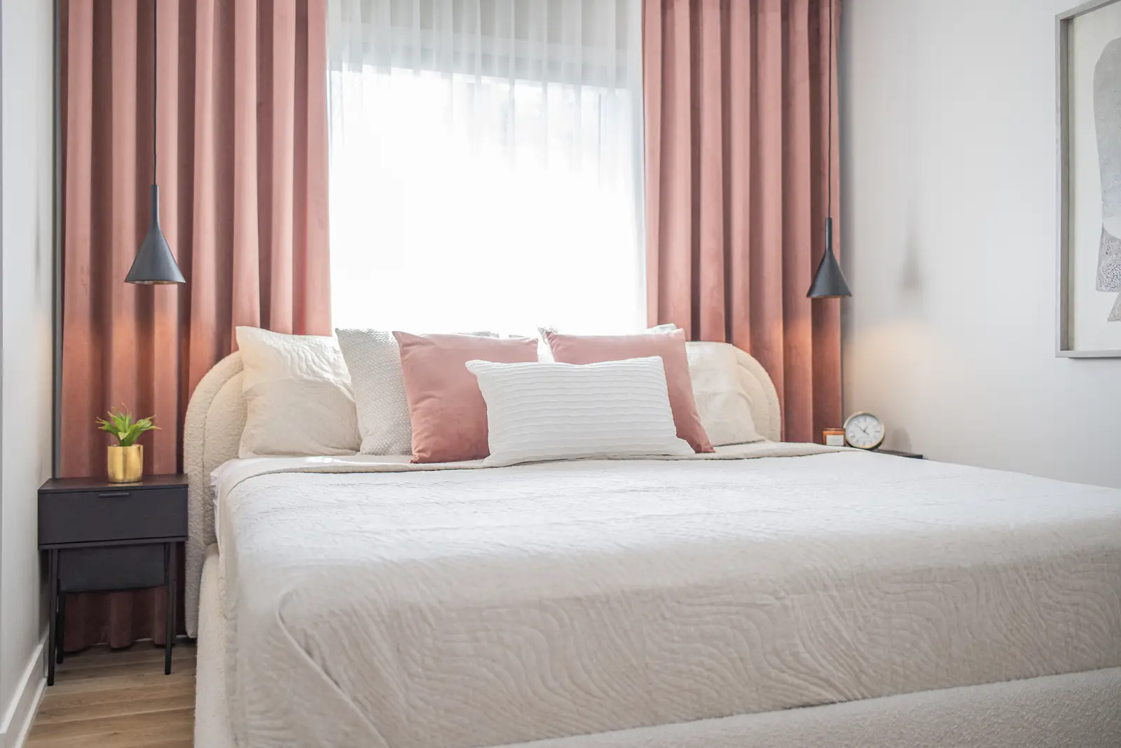 Interior of a house on Disney Court in Whitby, with a light living room, a white kitchen, and a bedroom in dusty rose.