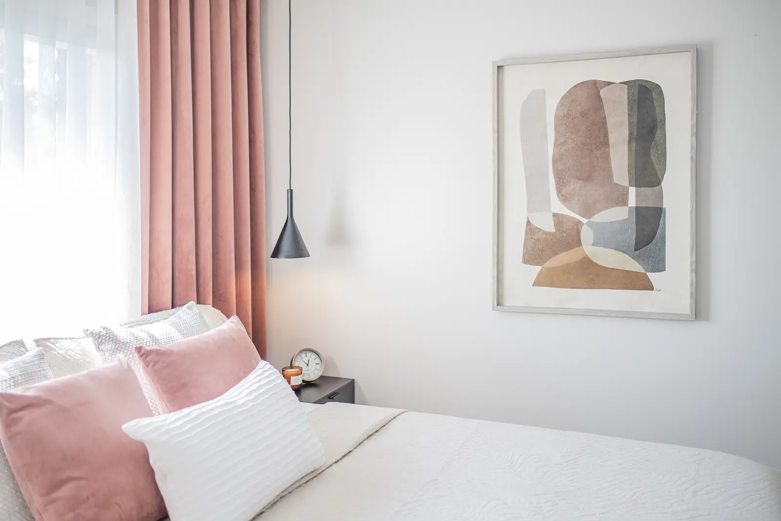 Interior of a house on Disney Court in Whitby, with a light living room, a white kitchen, and a bedroom in dusty rose.