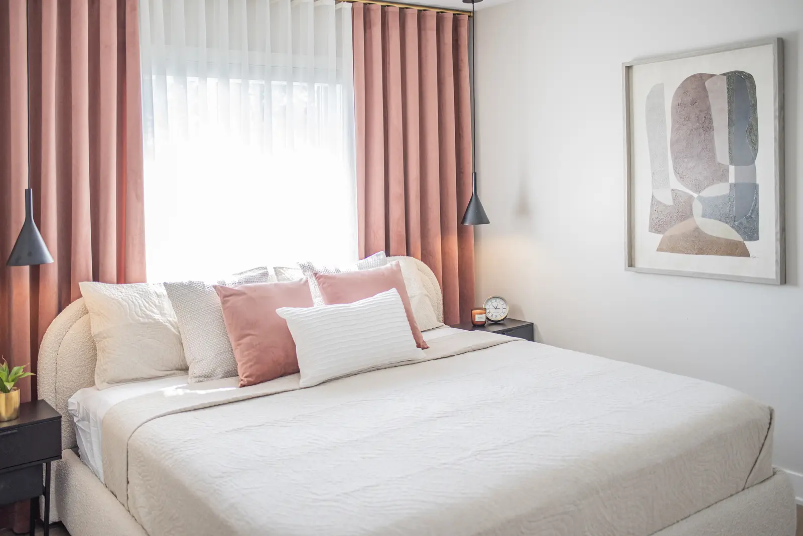 Interior of a house on Disney Court in Whitby, with a light living room, a white kitchen, and a bedroom in dusty rose.