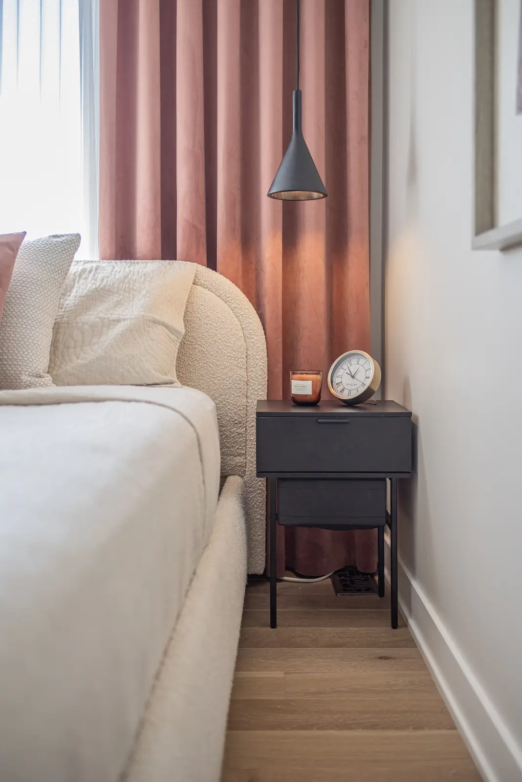 Interior of a house on Disney Court in Whitby, with a light living room, a white kitchen, and a bedroom in dusty rose.