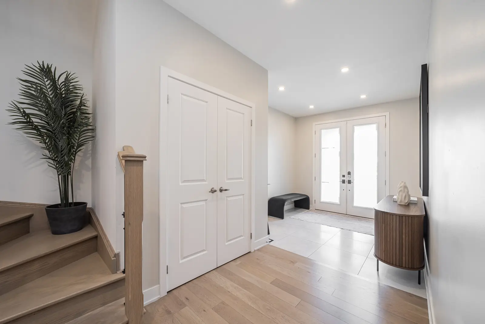Interior of a house on Disney Court in Whitby, with a light living room, a white kitchen, and a bedroom in dusty rose.