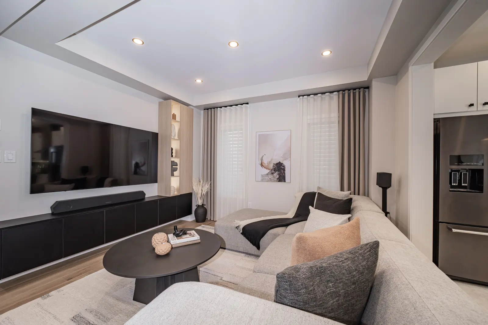 Interior of a house on Disney Court in Whitby, with a light living room, a white kitchen, and a bedroom in dusty rose.