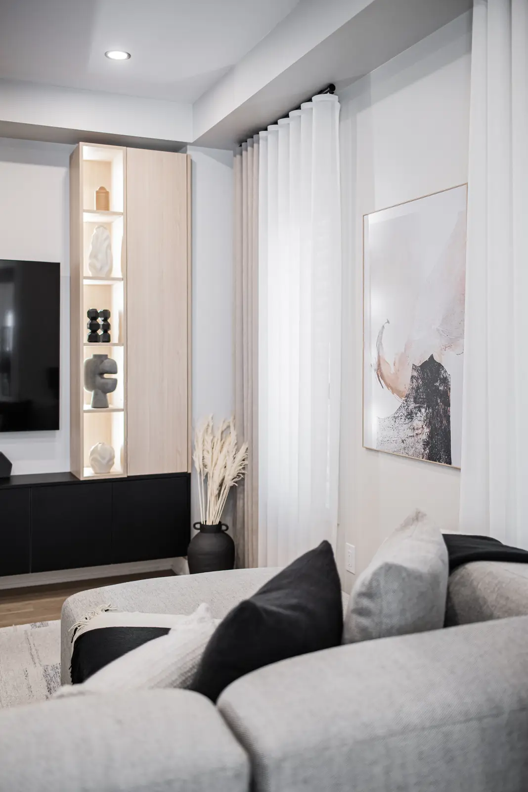 Interior of a house on Disney Court in Whitby, with a light living room, a white kitchen, and a bedroom in dusty rose.