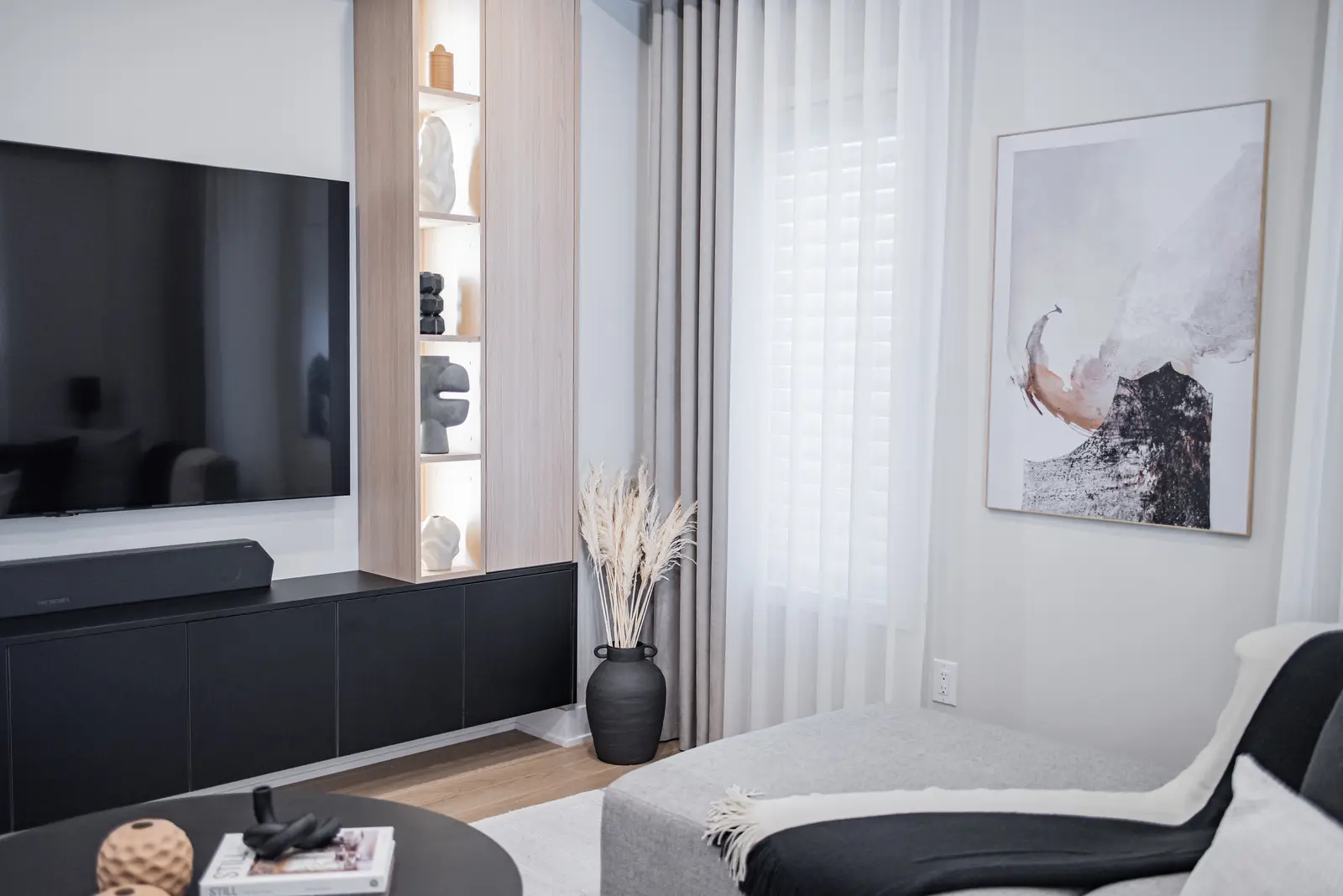 Interior of a house on Disney Court in Whitby, with a light living room, a white kitchen, and a bedroom in dusty rose.