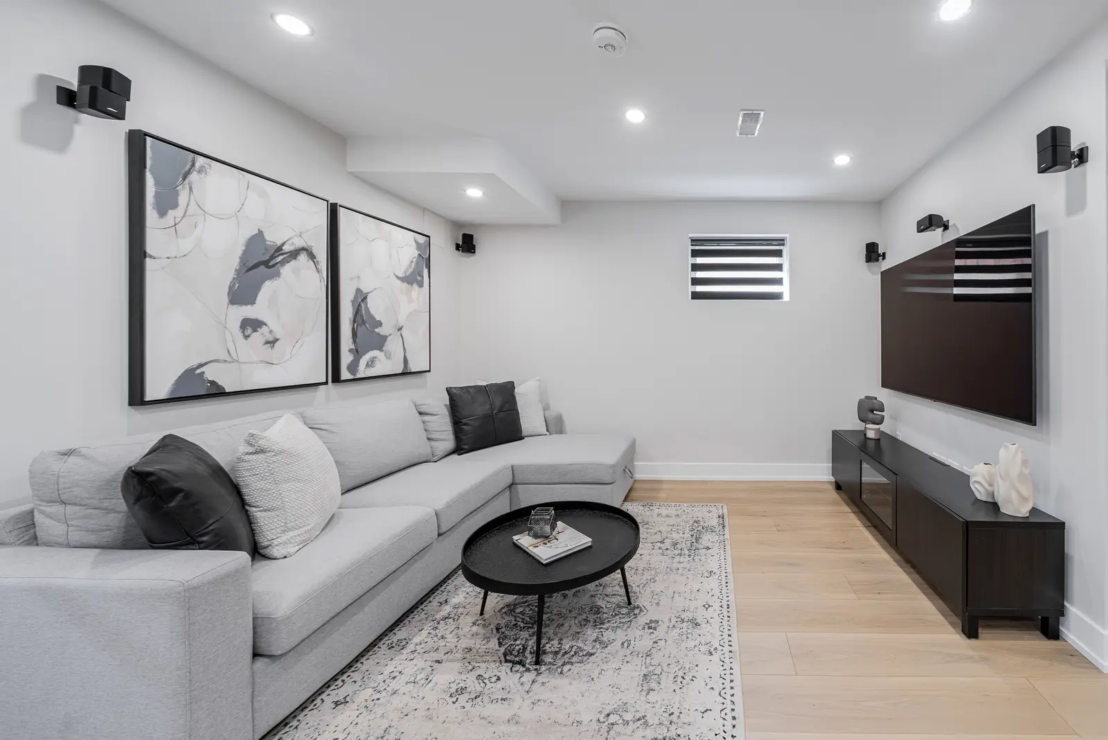 Interior of a house on Disney Court in Whitby, with a light living room, a white kitchen, and a bedroom in dusty rose.