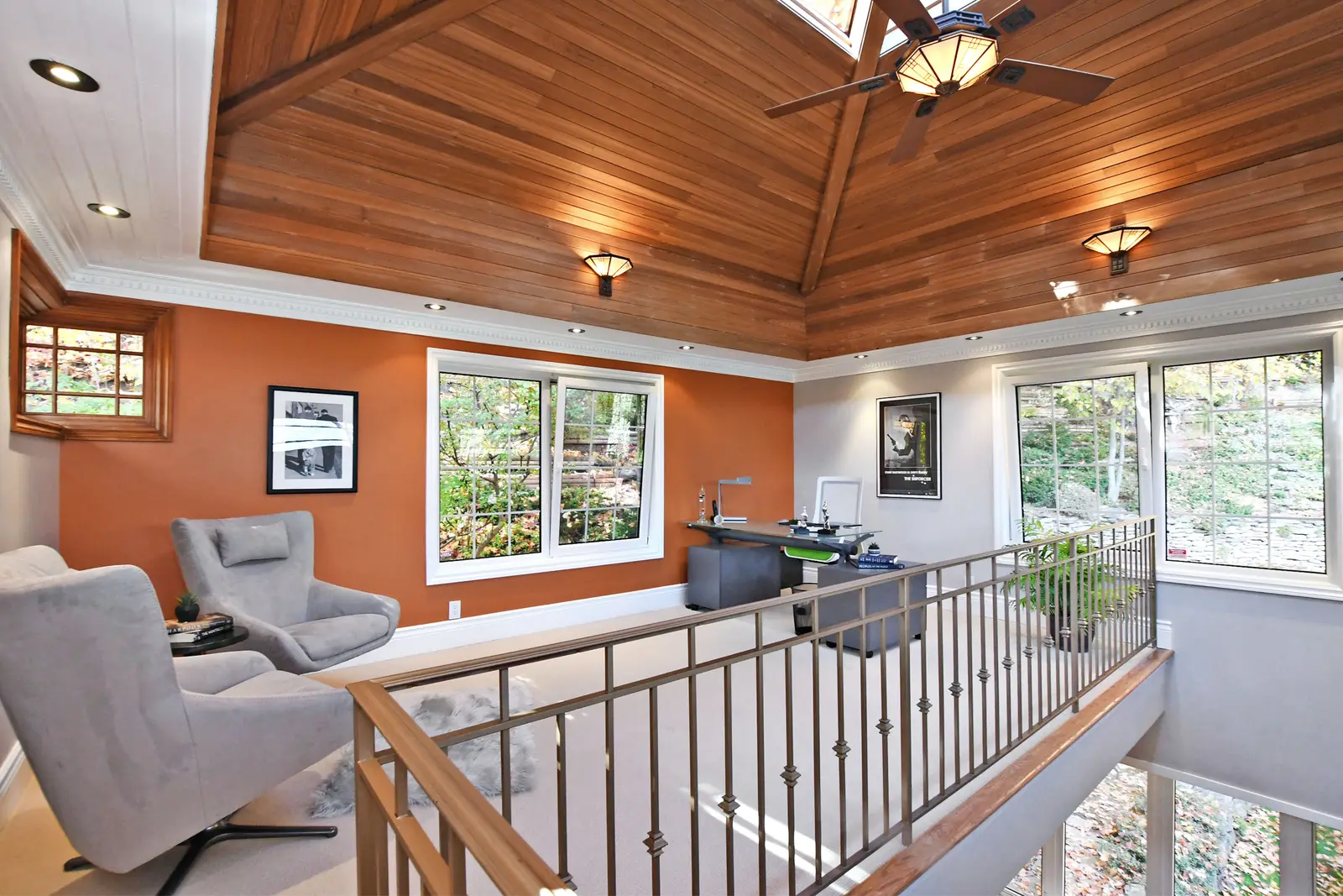 Interior of a house on Plymbridge Road in North York, with wood floors, a white kitchen, and windows onto the trees.