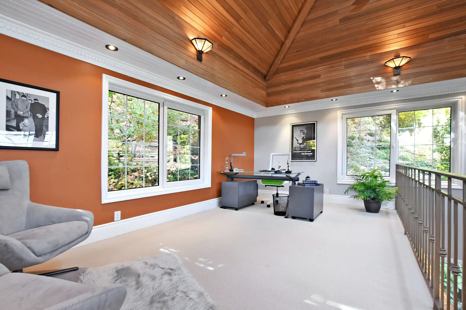 Interior of a house on Plymbridge Road in North York, with wood floors, a white kitchen, and windows onto the trees.