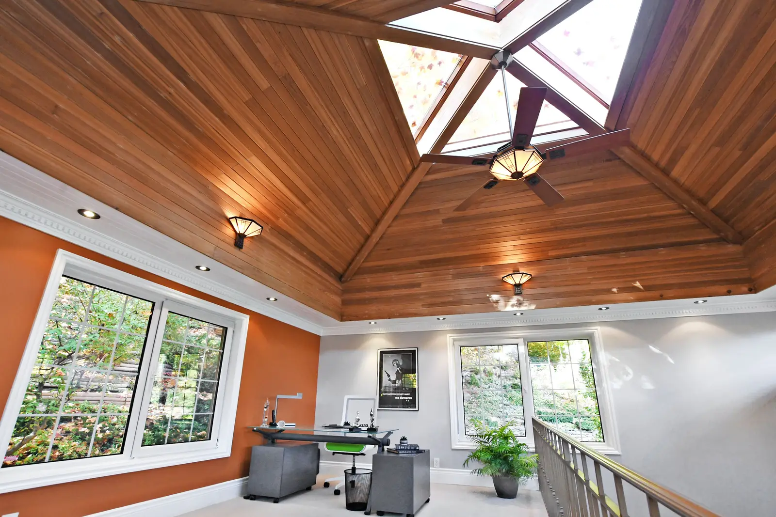 Interior of a house on Plymbridge Road in North York, with wood floors, a white kitchen, and windows onto the trees.