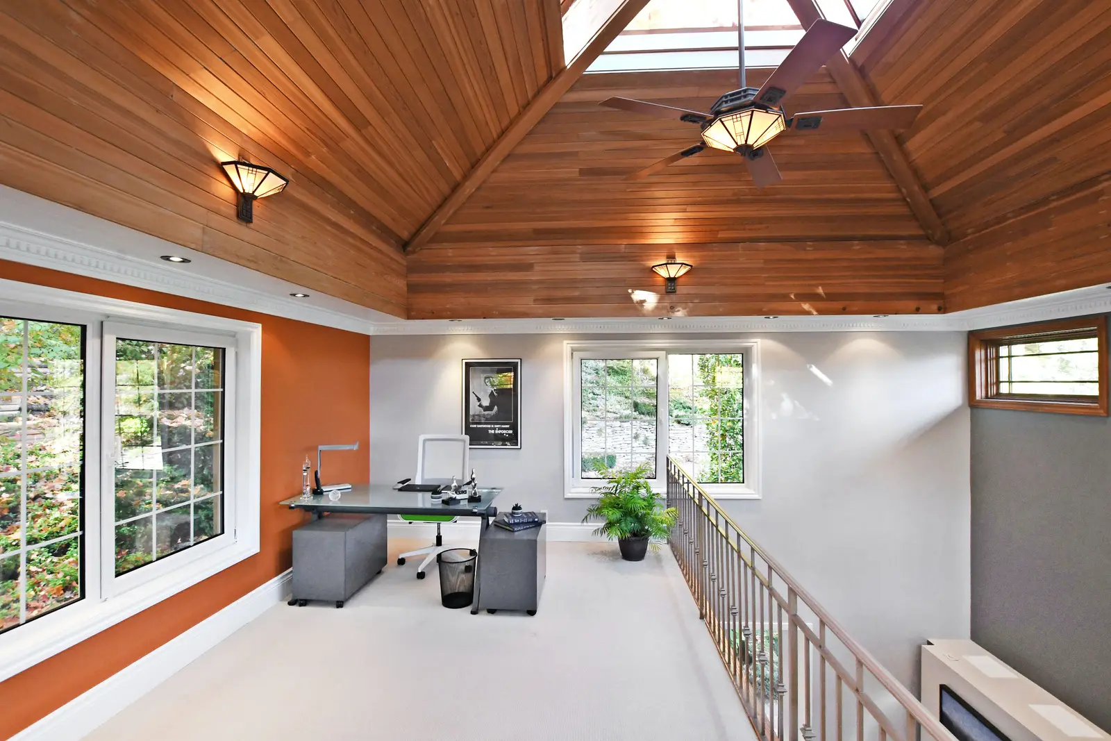 Interior of a house on Plymbridge Road in North York, with wood floors, a white kitchen, and windows onto the trees.